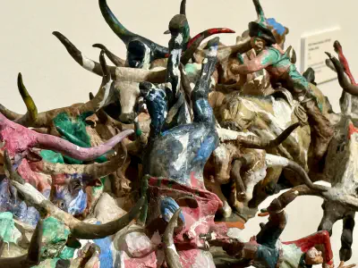 A sculpture of cattle and cowboys, painted with bright colors.